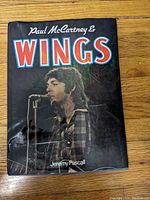 Front cover of the book showing the title, author, and an image of Paul McCartney singing into a microphone.