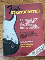 Front cover of The Fender Stratocaster book showing the guitar image and title text.