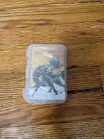Plastic wrapped transparent case containing the trading cards, showing artwork of a Zelda character on the cover card.