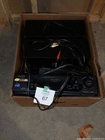 Box containing Sharp VHS player, Blu-ray disc player, and TEAC speakers with cables inside.