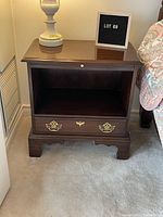 Side table with open cupboard, small drawer, and brass handles