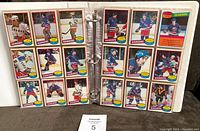Two pages of New York Rangers hockey cards laid in binder pages, showing multiple player cards.