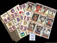 Photo showing hockey player stickers inserted in binder pages alongside team logo stickers, clear view of player names and team logos