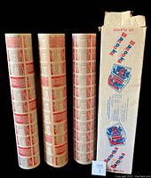 Three rolled uncut sheets of hockey cards and original factory box shown upright. Box with some torn top edges.