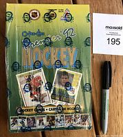 Front-facing view of the factory sealed 1992-93 OPC Premier hockey card wax box showing player card images and logos.