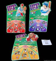 Three unopened 1990 Super Star MLB Collectible Action Marbles sets on original cards, featuring marbles with player faces and illustrated card toppers.