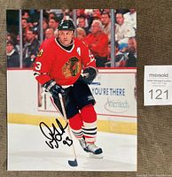 Full view of signed Doug Gilmour Chicago Blackhawks 8x10 photo on ice rink.