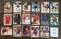 Top view showing 25 autographed NHL hockey cards arranged in rows on carpeted floor with signage.