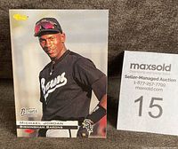 Front view of 1994 Michael Jordan Birmingham Barons baseball rookie card in black uniform with sunglasses on cap.