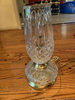 Clear crystal lamp with diamond and floral etching, brass accents, and crystal shade shown from full height on a wood floor.
