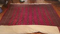 Full view of the entire rug laid flat on a wooden floor.