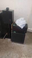Overview of speakers on stands, DS6 cubes and subwoofer in shelf