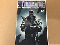 Front cover of Terminator: Secondary Objectives #1 comic book showing the robotic figure with red glowing eyes holding a rifle.