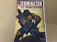 Front cover of Terminator The Enemy Within #2 comic book with painted art showing a muscular cyborg holding guns.