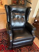 Front view showing tufted back, rolled arms, seat cushion