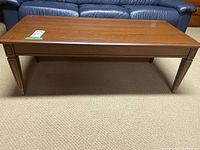 Full view of the rectangular wood coffee table showing its length and top surface.