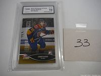 Front of hockey card in protective case showing Conner McDavid in Erie Otters uniform with grading label Gem Mint 10