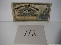 Front view of aged Dominion of Canada 25 cents bank note with denomination, date and seated figure.