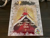 Front view of the 2007 Holiday Barbie doll inside original box showing red gown and snowflake frosted box design.