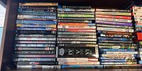 Drawer containing various DVD and Blu-Ray movie titles organized spine out for visibility