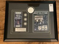 Framed commemorative with plaque, coins, embossed emblem, and photos, showing entire lot contents.