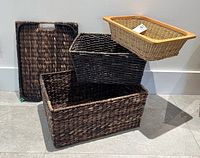 Group of five baskets arranged on floor showing colors and sizes.