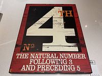Front view of vintage inspired wooden art sign showing number 4 and surrounding text in white on red and black background.