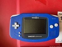 Front view of blue Nintendo Game Boy Advance with Toys"R" Us logo.