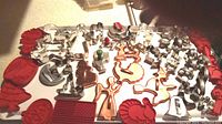 Large variety of metal and red plastic cookie cutters in multiple shapes and sizes including holiday and floral themes