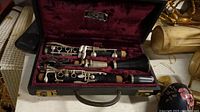 Clarinet with keys and mouthpiece in red velvet-lined black hard case.