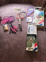 Full view of all items including racquets, boxed volleyball net, croquet set and shuttlecocks