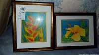 Two framed art prints showing Heliconia and Yellow Hibiscus flowers by K. L. Thrasher, both 13x16 inches.