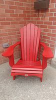 Front view of the red Leisure Line Muskoka chair showing the full chair design and wide armrests.