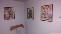 Photo showing three framed prints on wall with Norman Rockwell artwork depicting a man reading to a child and other scenes.