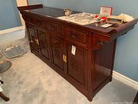 Angled front left view showing four drawers and two cabinet doors