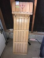 Top view of the wooden sled showing the flat slatted seating area and metal reinforcements at the front.