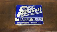 Photo of the top of the sealed blue and white box labeled 1988 Topps Baseball Traded Series showing card numbers 1-T through 132-T.