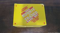 Photo of the front and top of original yellow box for 1990 Score Baseball Rookie & Traded card set.