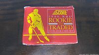Original box of the 1990 Score NHL Rookie and Traded 110 player card set showing front with red and yellow design and hockey player illustration.