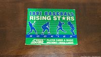 Green box of 1991 Score Baseball Rising Stars Rookies with player silhouettes.
