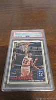 Front view of the 1995 Michael Jordan basketball card graded PSA 6 in protective slab showing action shot of player near basket with PSA label visible.
