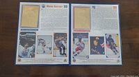 Open pages inside the book displaying 22kt gold embossed rookie and career cards of Wayne Gretzky with text and color action photos