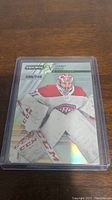 Photo of Carey Price short print hockey card numbered 230/749 in clear protective case on wooden surface.