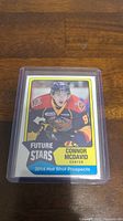 Photo of Connor McDavid 2014 Hot Shot Prospects Future Stars rookie hockey card in protective sleeve.