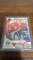 Full view of Curtis Joseph hockey card in protective sleeve showing player in red goalie uniform.