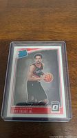 Front of Gary Trent Jr rookie basketball card showing player in Portland Trail Blazers uniform with basketball, set in a red and white bordered Panini Donruss Optic card.