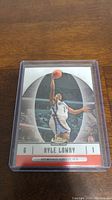 Clear image of Kyle Lowry rookie basketball card in protective casing, showing front of the card with player image, team name, and rookie details.