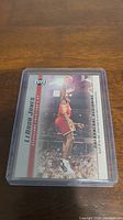 Photo of LeBron James rookie card by Upper Deck showing action dunk shot in plastic protective case.