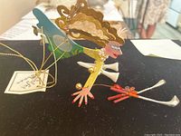 Ornament front angle showing golfer woman pose, colors and painted details