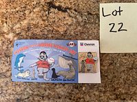 San Francisco Giants Lou Seal mascot pin attached to Marine Mammal Day themed cardboard packaging with Chevron sponsorship logos and ocean mammal illustrations.